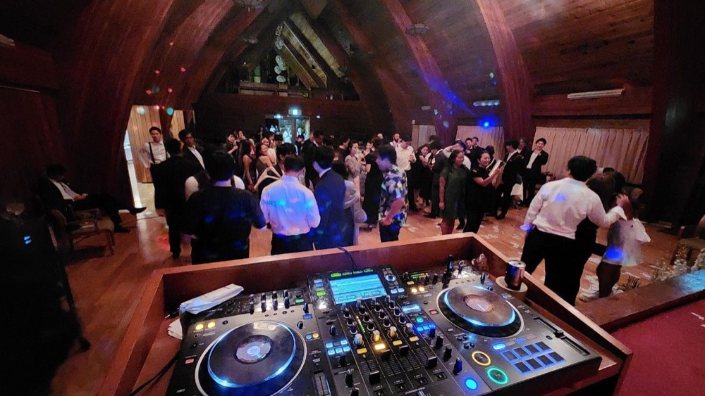 DJブースから見た、木造ホールのフロアとゲスト